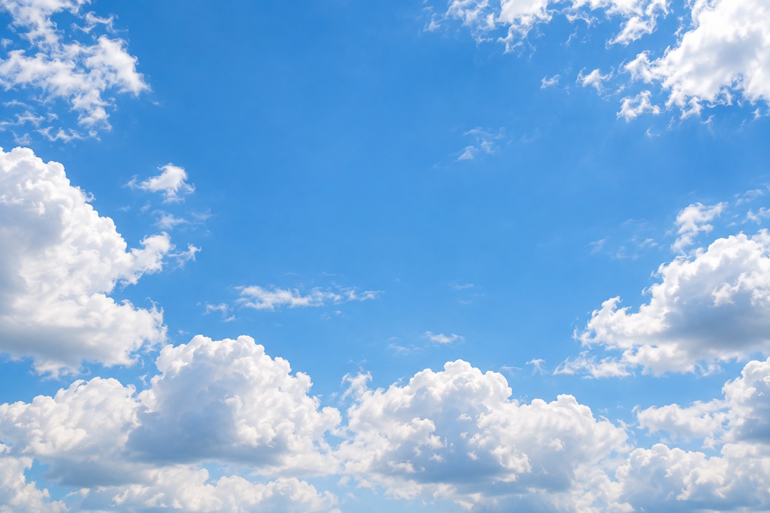 Blue sky with sunlit clouds